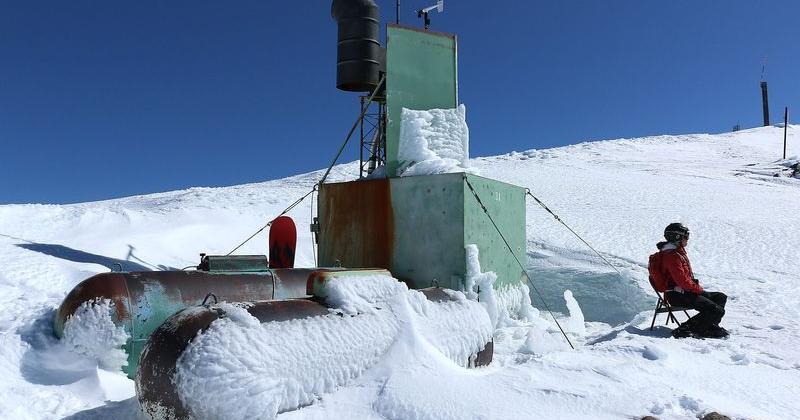 Desert Research Institute Science Writer Kelsey McCutcheon Fitzgerald sits and takes in a view next to a cloud seeding generator at Alpine Meadows Ski Resort in California on Feb. 25, 2021.