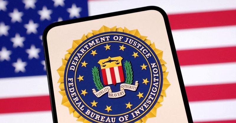 FILE PHOTO: Illustration shows United States Department of Justice logo and U.S. flag | Top News