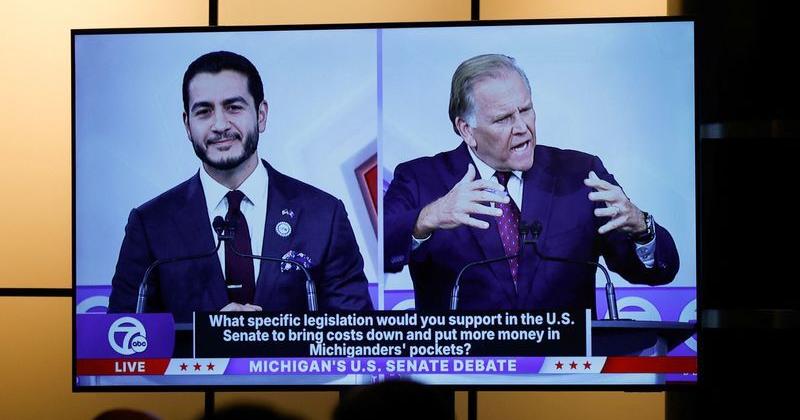 Democratic nominee for US Senate Abdul El-Sayed and Republican nominee for US Senate Mike Rogers are seen on a screen in the media room during their US Senate debate