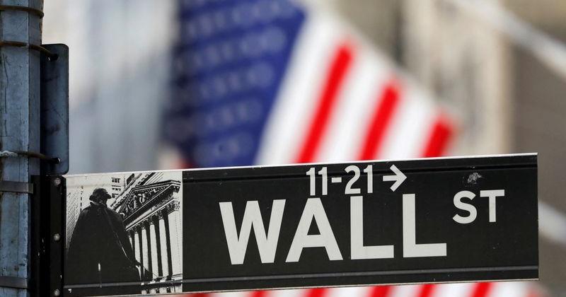 FILE PHOTO: A street sign for Wall Street is seen outside the New York Stock Exchange (NYSE) in New York City