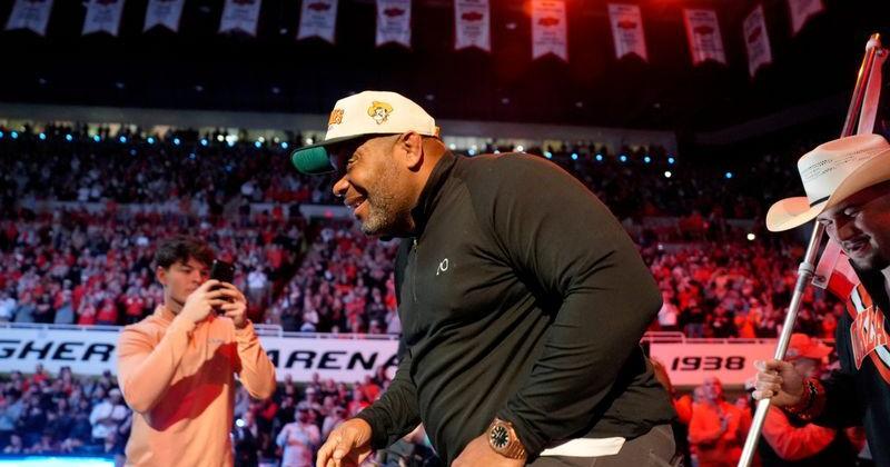 Former Oklahoma State wrestler Daniel Cormier leads the Cowboys out before a college wrestling dual between the Oklahoma State