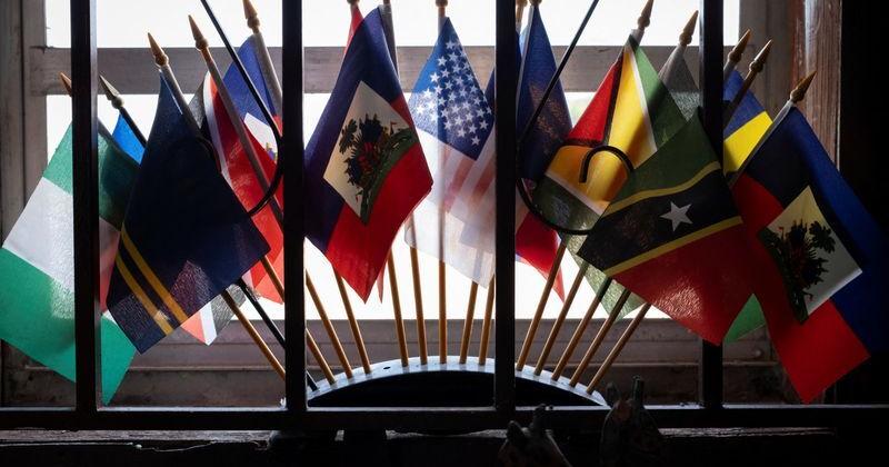 Haitian and U.S. flags sit among others at a bookstore in the Little Haiti neighborhood in Miami | Top News