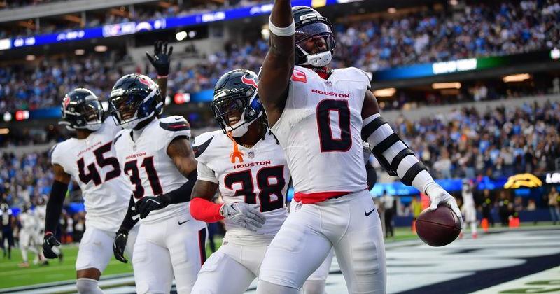 Dec 27, 2025; Inglewood, California, USA; Houston Texans linebacker Azeez al-Shaair (0) reacts with safety K'Von Wallace (38) after making an interception against the Los Angeles Chargers during the first half at SoFi Stadium. Mandatory Credit: Gary A. Vasquez-Imagn Images