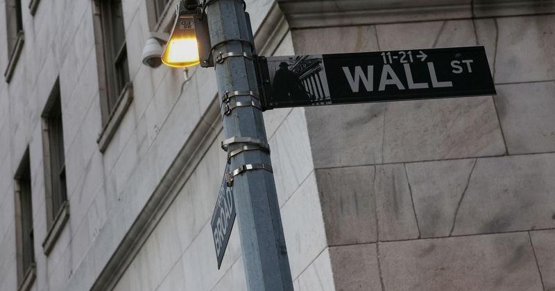 The Wall street sign hangs outside the New York Stock Exchange (NYSE) building on Tuesday following Monday’s broad sell off in New York City