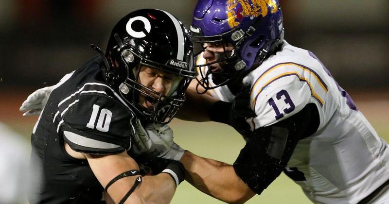 Lubbock-Cooper's Jathan Caraway (10) is tackled by Abilene Wylie's Bo Kates in a District 2-5A Division II football game Friday, Oct. 31, 2025, at Pirate Stadium in Woodrow.