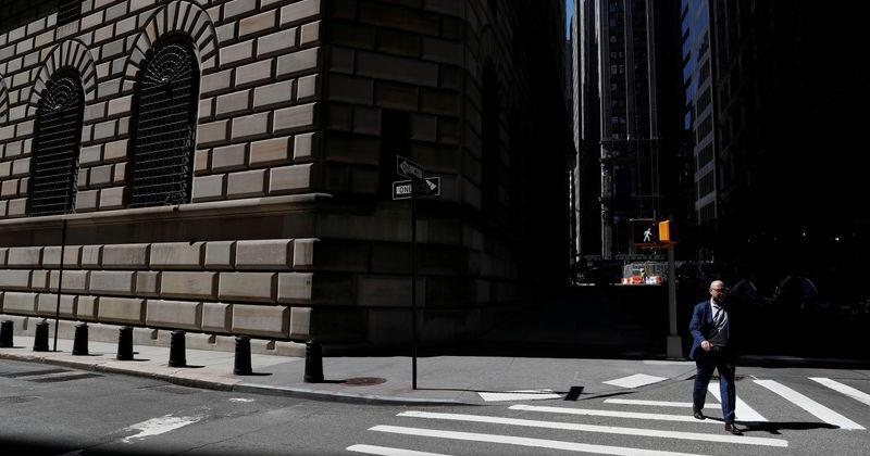 A man walks by the Federal Reserve Bank of New York Building in New York City