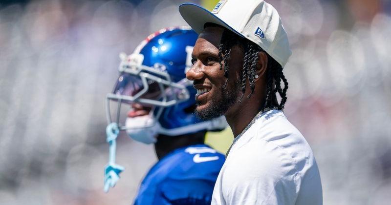 New York Giants wide receiver Malik Nabers (1), not suited up for the game, stands his his teammates during warm ups during a