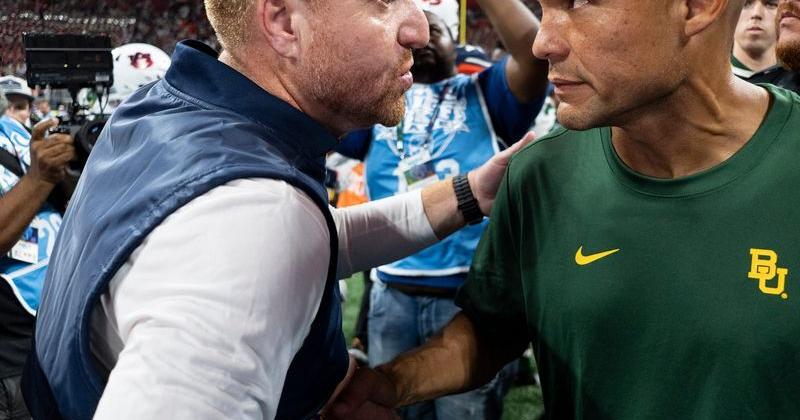 Auburn Tigers head coach Alex Golesh and Baylor Bears head coach Dave Aranda shake hands after the game as Auburn Tigers take on Baylor Bears in the Aflac Kickoff Game at Mercedes-Benz Stadium in Atlanta, Ga. on Saturday, Sept. 5, 2026. Auburn Tigers defeated Baylor Bears 17-16.