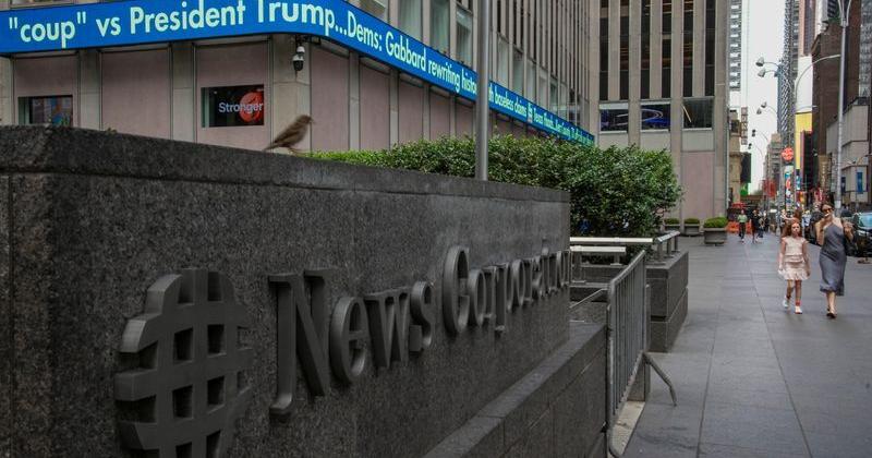 Electronic news ticker of Fox News reads headlines at News Corp. Building in Midtown area of New York