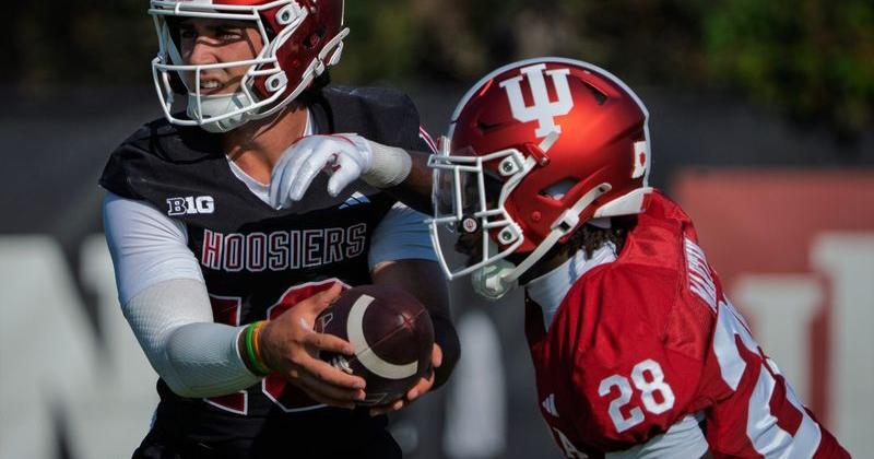 Indiana's Josh Hoover (10) hands off to Khobie Martin (28) during Indiana University's football camp practice on Wednesday, Aug. 5, 2026.
