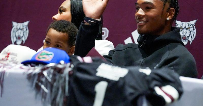 Benjamin Russell High School quarterback Kingston Preyear waves to the ESPN audience as he announces that he is committing to the University of Alabama during a ceremony in Alexander City, Ala., on Friday July 10, 2026.