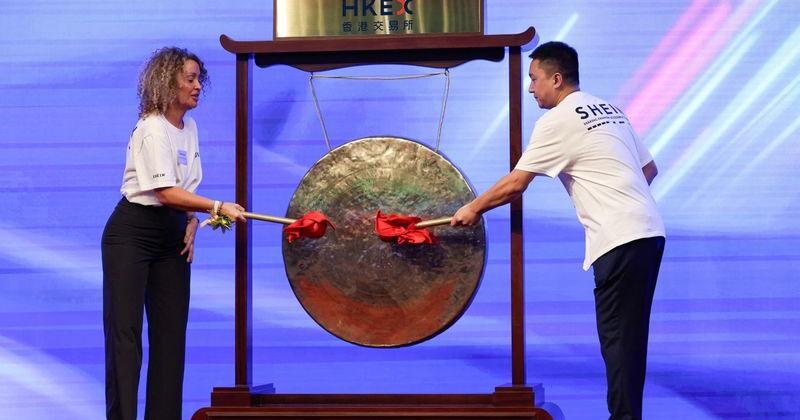 Shein representatives strike a ceremonial drum during the listing ceremony of online retailer Shein at the Hong Kong Stock Exchange, in Hong Kong
