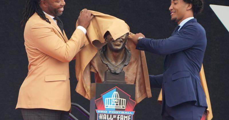 Pro Football Hall of Fame enshrinee Larry Fitzgerald and his son Devin Fitzgerald unveil his bust during the Class of 2026