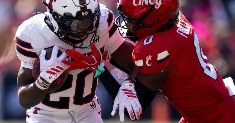 Cincinnati Bearcats cornerback Jacob Finley (0) tackles Texas Tech Red Raiders running back I'Koby Williams (20) in the third quarter of the Big 12 game between Cincinnati Bearcats and Texas Tech at Nippert Stadium in Cincinnati on Saturday, October 24, 2026.