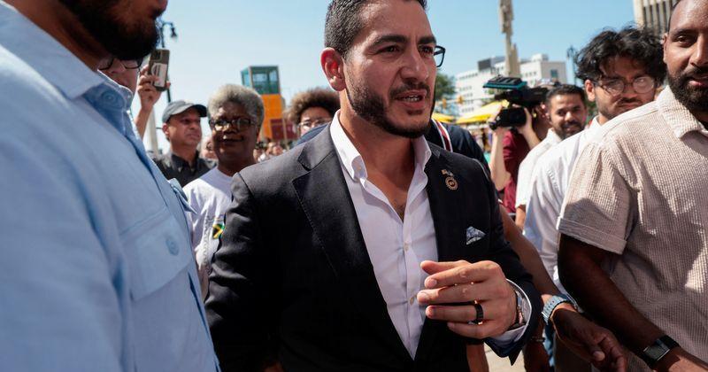 Abdul El-Sayed, winner of Michigan U.S, Democratic primary, is escorted out following a press conference in Detroit,