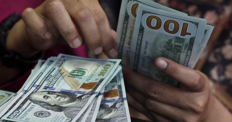 Dollar slips as markets weigh Fed rate outlook; yen hovers near 160