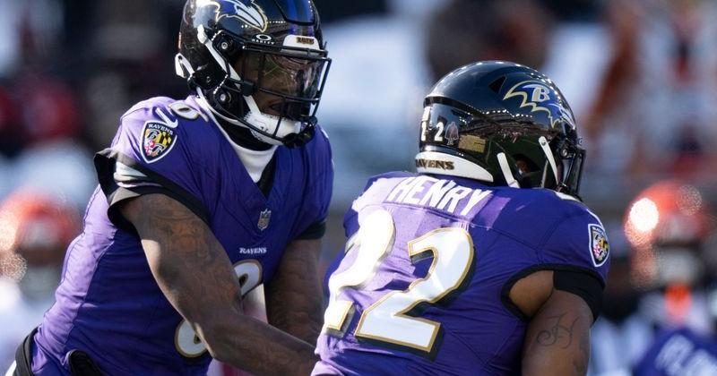 Baltimore Ravens quarterback Lamar Jackson (8) hands off the ball to Baltimore Ravens running back Derrick Henry (22) in the