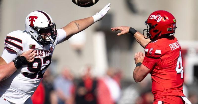 Cincinnati Bearcats quarterback JC French IV (4) throws a pass as Texas Tech Red Raiders defensive lineman Bryce Butler (92)