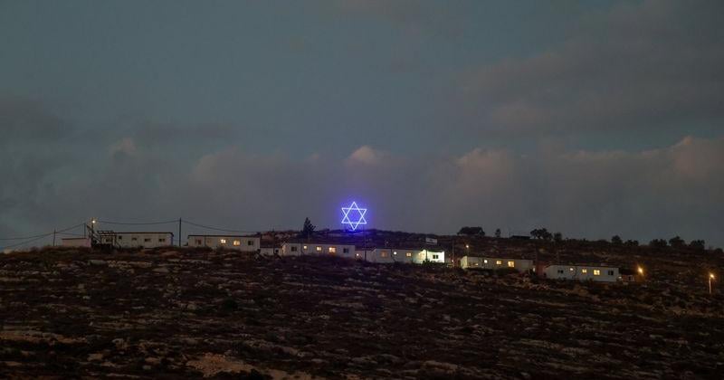 An illuminated Star of David above an Israeli settlers outpost near Ramallah