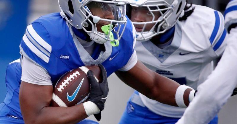 Middle Tennessee State running back Brooklen Davis (33) carries the ball as Middle Tennessee State inside linebacker Jayson Lowe (17) puts on the pressure during Middle Tennessee State University's spring football practice on Friday, April 24, 2026.