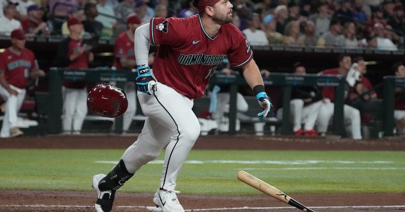 Arizona Diamondbacks third baseman Tim Tawa (13) hits a sacrifice fly against the San Diego Padres during an MLB game at Chase Field in Phoenix, Arizona.