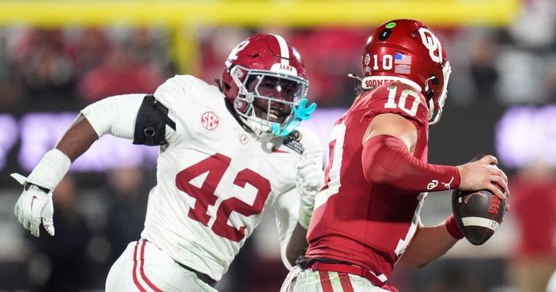 Oklahoma's John Mateer (10) is pressured by Alabama's Yhonzae Pierre (42) in the second half of the College Football Playoff game between the University of Oklahoma Sooners (OU) and the Alabama Crimson Tide at the Gaylord Family-Oklahoma Memorial Stadium in Norman, Okla., on Dec. 19, 2025.
