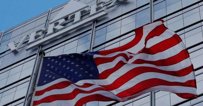A U.S. flag flies in front of the world headquarters of Vertex Pharmaceuticals in Boston