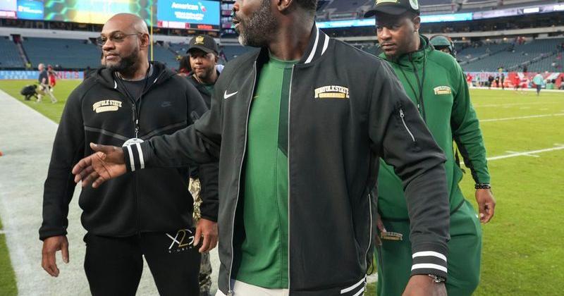 Norfolk State head coach Michael Vick greets fans as he walks around the field prior to his team playing Delaware State at