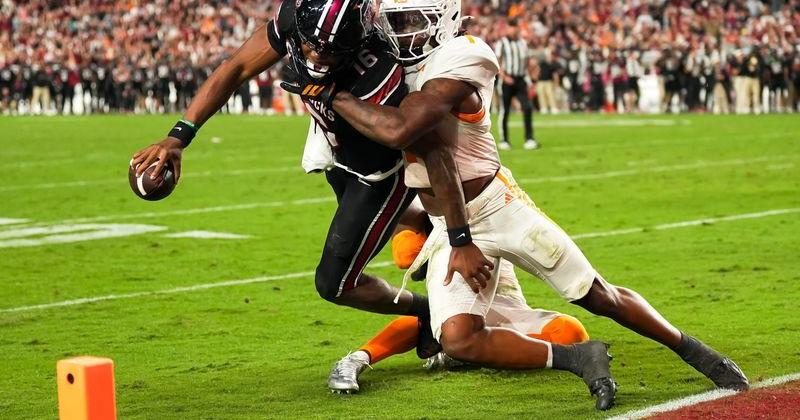 South Carolina quarterback LaNorris Sellers (16) fights a tackle attempt by Tennessee defensive back TJ Metcalf (1) to reach the end zone for a touchdown during the fourth quarter at Williams-Brice Stadium.