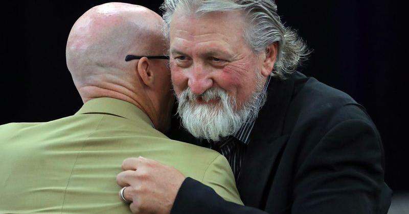Former Zips basketball coach Bob Huggins, facing, hugs current coach John Groce after speaking during the Akron Basketball