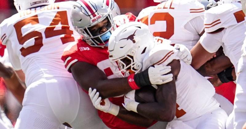 Ohio State Buckeyes defensive lineman Kayden McDonald (98) tackles Texas Longhorns running back CJ Baxter (4) during the NCAA football game at Ohio Stadium on Aug. 30, 2025.