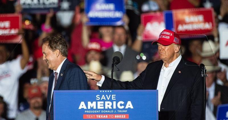 Former president Donald Trump pats Texas Attorney General Ken Paxton on the shoulder as he leaves the stage during a rally at the Richard M. Borchard Regional Fairgrounds in Robstown, Texas on Saturday, Oct. 22, 2022.