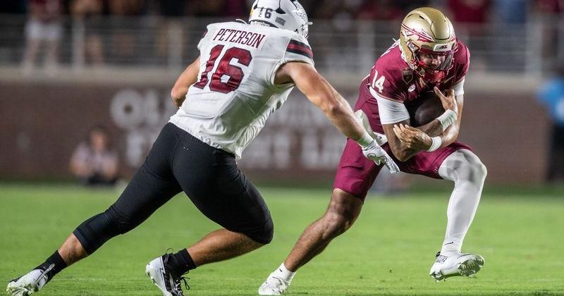 Florida State Seminoles quarterback Ashton Daniels (14) is chased by NMSU defensive end Gabe Peterson. The Florida State Seminoles defeated the New Mexico State Aggies 34-17 at Doak Campbell Stadium on Saturday, Aug. 29, 2026.