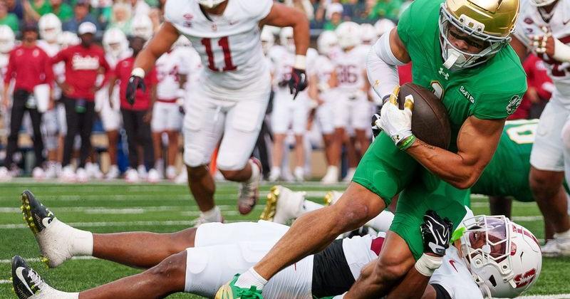 Notre Dame wide receiver Jaden Greathouse falls into the end zone for a touchdown during a NCAA football game against Stanford