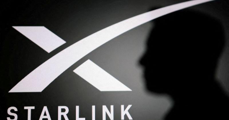 FILE PHOTO: Illustration shows silhouette of Elon Musk and Tesla logo