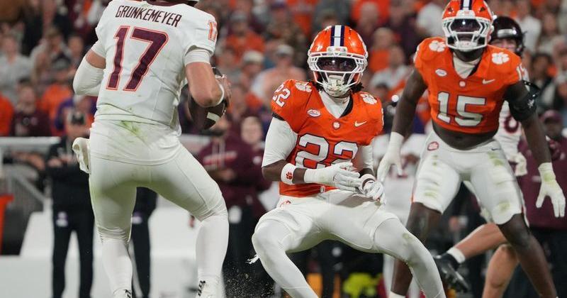 Virginia Tech Hokies quarterback Ethan Grunkemeyer (17) passes a ball despite pressure from Clemson safety Corey Myrick (22) and