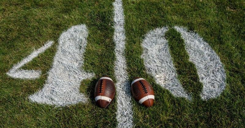 Footballs are seen on the 40 yard line before a high school football game between Revere and Akron Garfield, Aug. 29, 2026, at