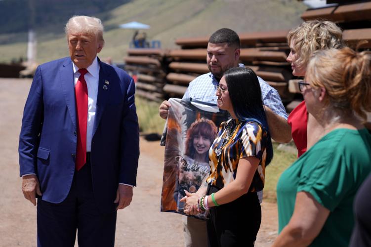 Trump uses a stretch of border wall and a pile of steel beams in