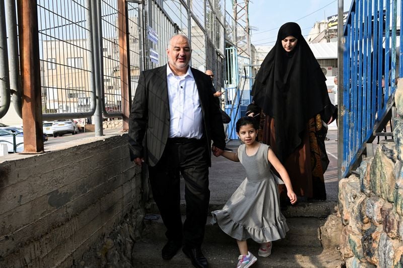 Palestinian candidate Mansour, Abbas leader of the Ra'am party walks  towards a polling station with his wife and daughter, on the day of  Israel's national election, in Maghar | Top News |