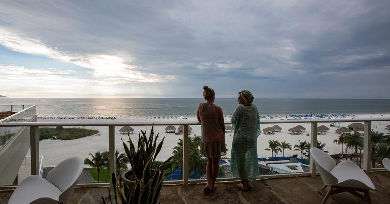 Mother and daughter take in the beach view in Hawaii.