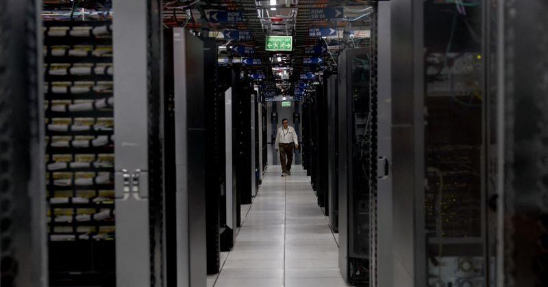 FILE PHOTO: An employee walks through a data centre of Hewlett Packard Enterprise (HPE) inside its office building in Bengaluru