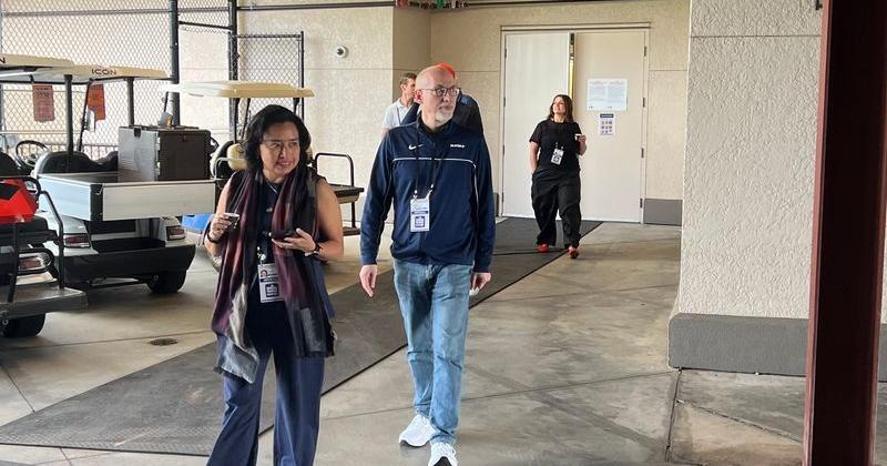MLB Players Association interim executive director Bruce Meyer (middle) walks alongside MLBPA associate director Silvia Alvarez