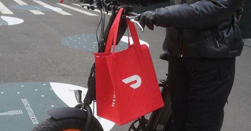 A DoorDash delivery person is pictured on the day they hold their IPO