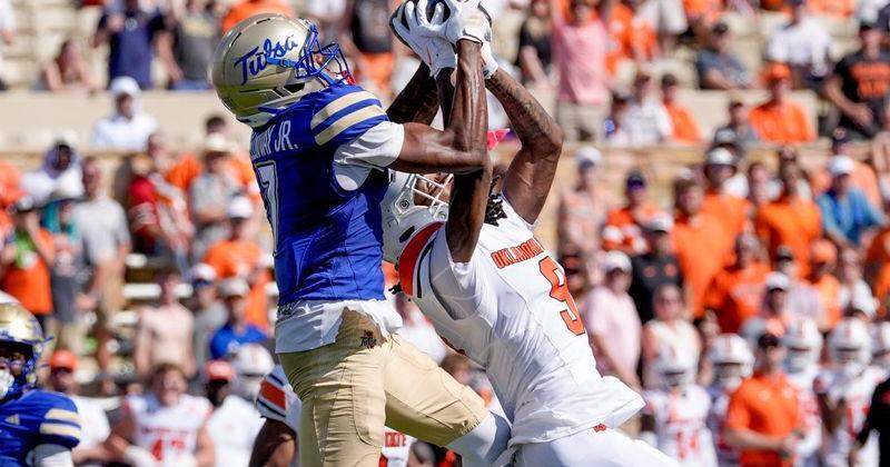 Tulsa wide receiver Jimmy Calloway (7) catches a pass over Oklahoma State cornerback LaDainian Fields (9) during the first half