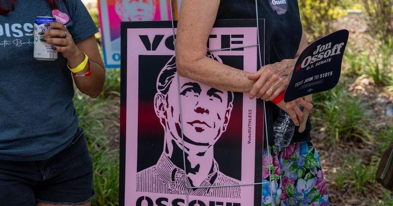 A supporter carries a Sen. Jon Ossoff campaign sign following a united campaign rally with Sen. Jon Ossoff and Democratic gubernatorial candidate Keisha Lance Bottoms on Saturday, June 27, 2026, in Savannah, Ga.