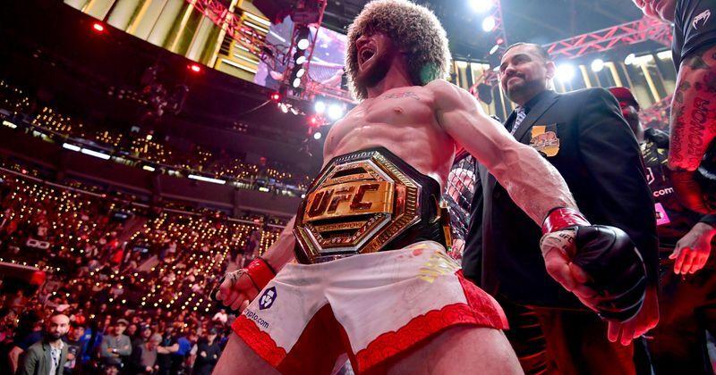 Jan 18, 2025; Inglewood, California, USA; Merab Dvalishvili (red gloves) celebrates after winning a UFC bantamweight title fight against Umar Nurmagomedov (not pictured) during UFC 311 at Intuit Dome. Mandatory Credit: Gary A. Vasquez-Imagn Images