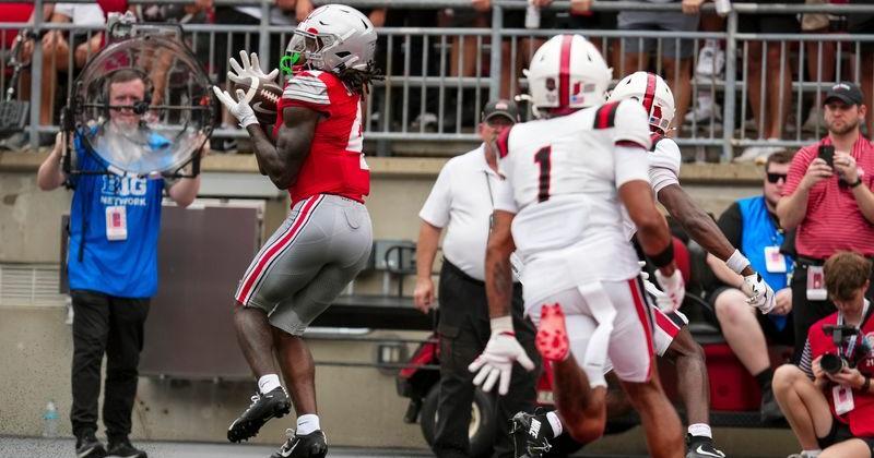Ohio State Buckeyes wide receiver Jeremiah Smith (4) catches a pass during the NCAA football game against the Ball State