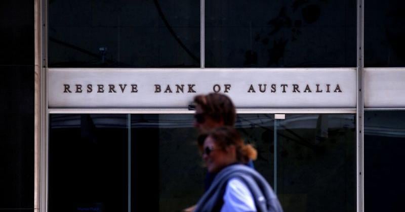 Pedestrians walk past the main entrance to the Reserve Bank of Australia building in central Sydney, Australia