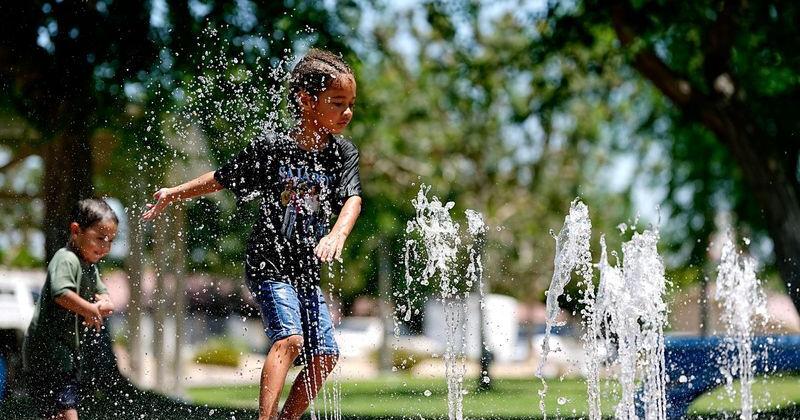 Bryson Diggz, 5, cools off in the water feature as temperatures reach over 110 degrees at Ocotillo Park in Cathedral City, Calif., on August 1, 2026.