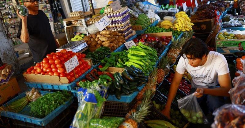 A worker sells fruits and vegetables at a market in Ciudad Juarez, Mexico, April 15, 2026